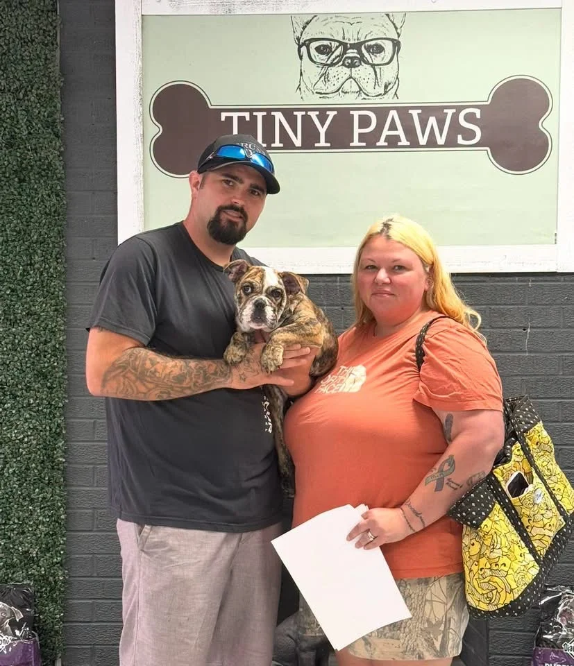 A family with their puppy at Tiny Paws